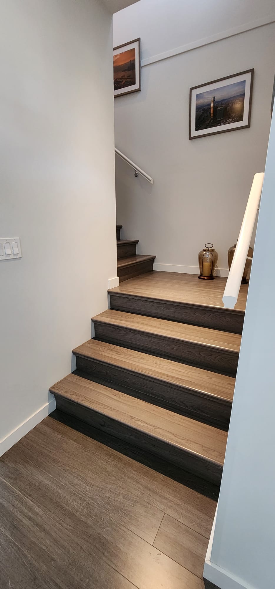 Staircase after — wood-look laminate treads and risers